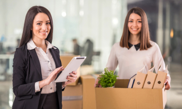 Two female businesswomen moving into a new office